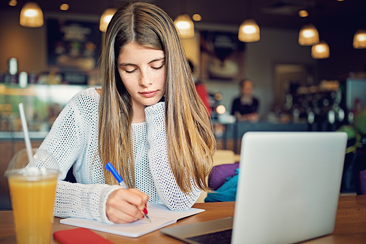 Female College Student Studying in a Cafe