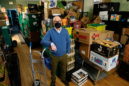 A man at the Friendship Center stock room