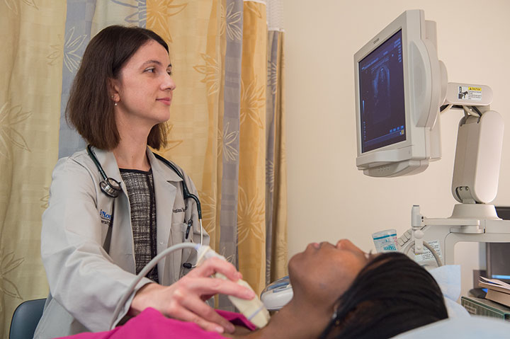 Dr. Kristina Todorova-Koteva performing a thyroid ultrasound on her patient.