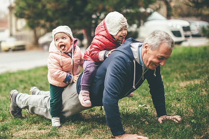 Grandpa doing pushups with grandchildren on his back