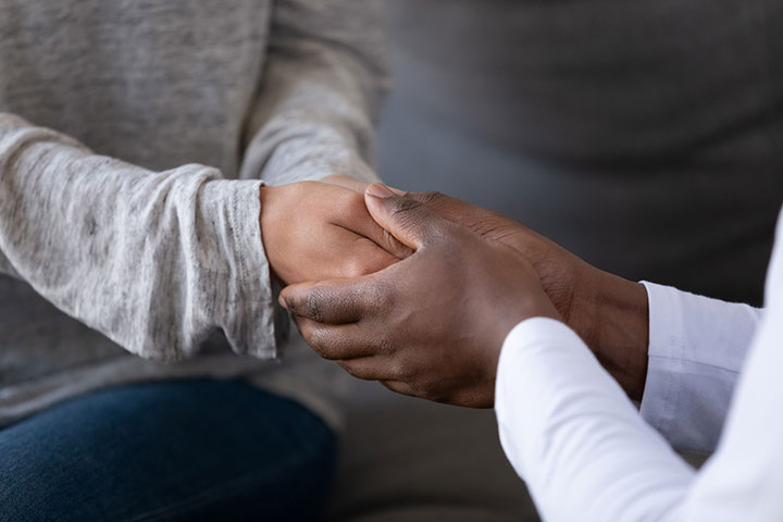 Two people holding hands