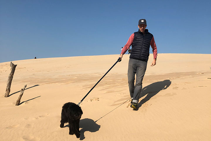 Walking a dog in the sand