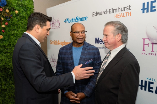 Dr. Ravi Bashyal, orthopaedic surgeon, talks with Mike Singletary and Dr. Julian Bailes, neurosurgeon.