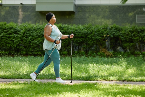 woman walking with walking sticks