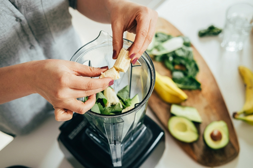 Hands holding banana to make smoothie