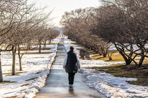 Woman walking down a road