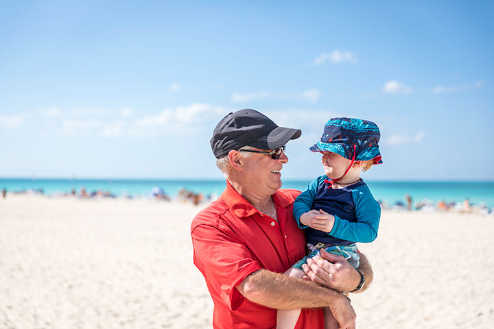 Grandfather and child on beach